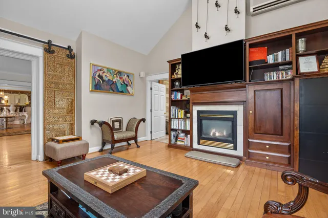 a living room with furniture a flat screen tv and a fireplace