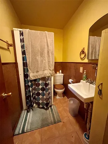 a bedroom with bed and a chandelier