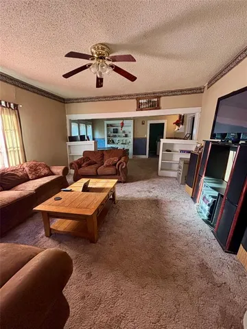 a bedroom with furniture and a flat screen tv