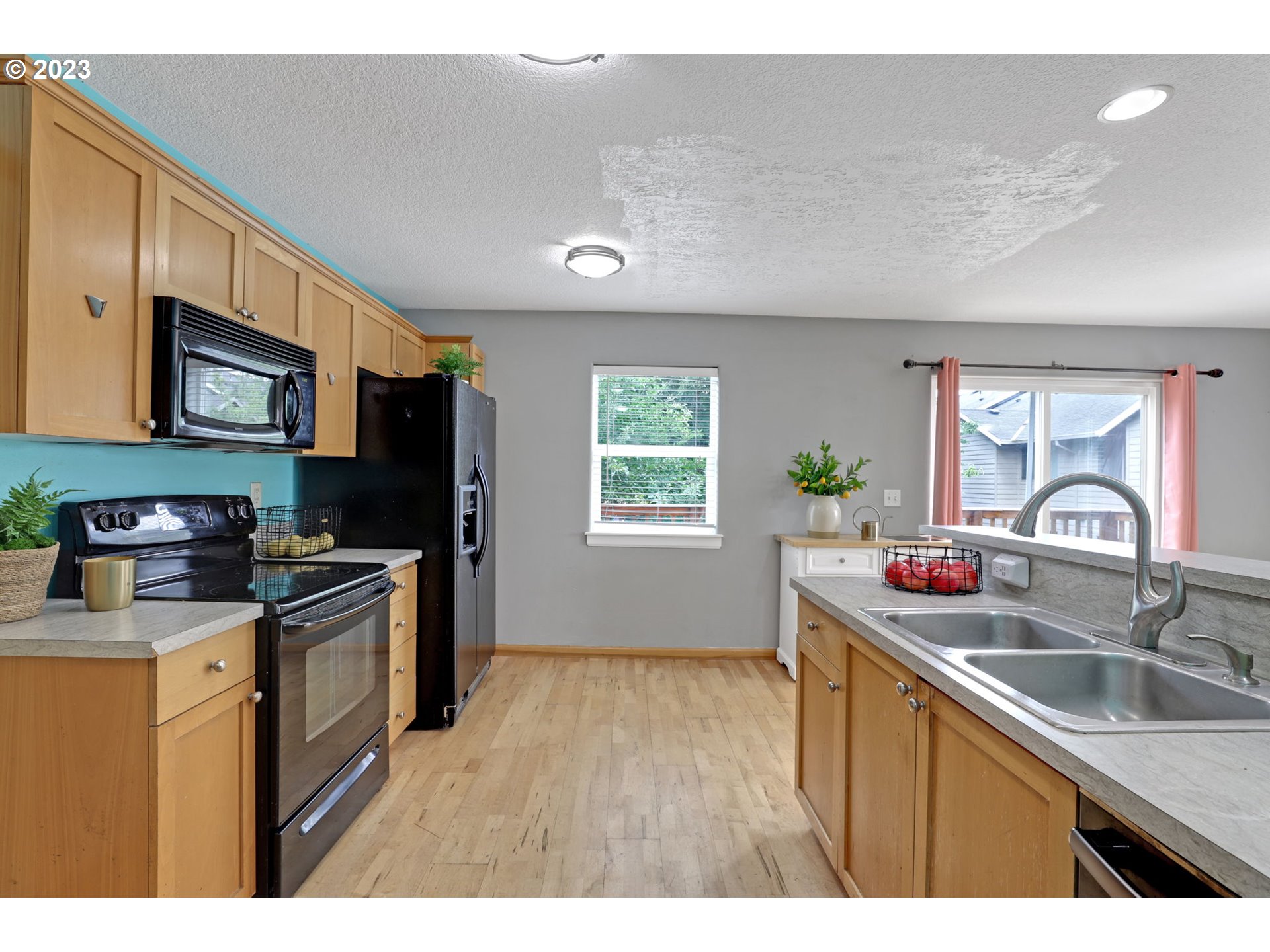 38909 Sandy Heights Street Sandy, OR 97055 - Photo 15 of 33 a kitchen with kitchen island granite countertop a sink stainless steel appliances and counter space