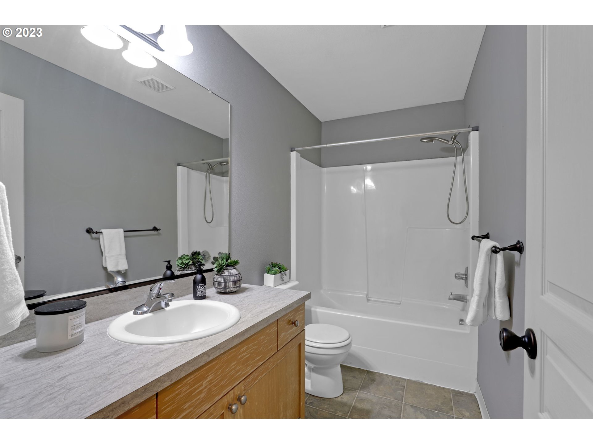 38909 Sandy Heights Street Sandy, OR 97055 - Photo 26 of 33 a bathroom with a granite countertop sink a toilet a mirror and shower