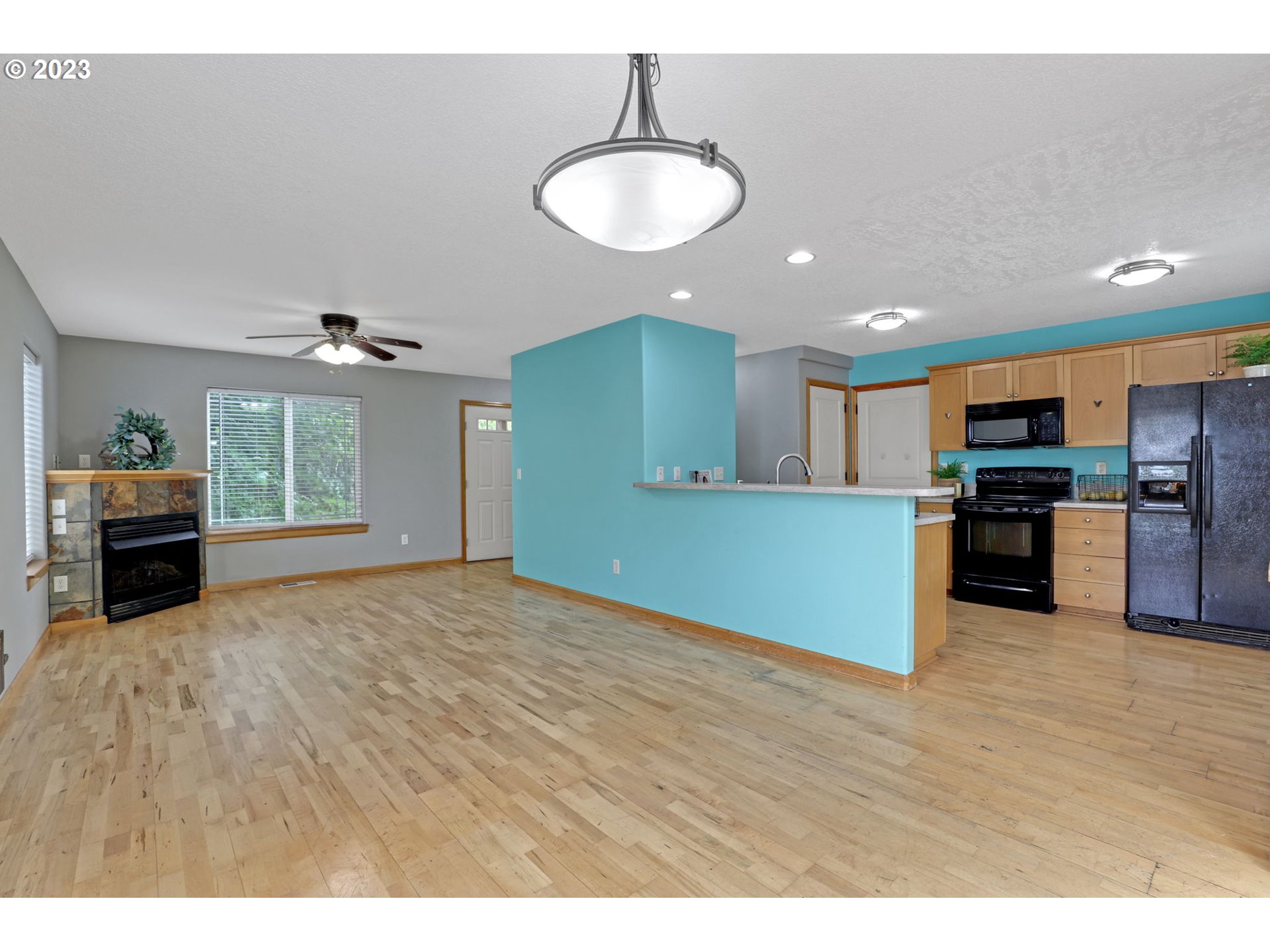 38909 Sandy Heights Street Sandy, OR 97055 - Photo 8 of 33 a kitchen with kitchen island granite countertop stainless steel appliances refrigerator oven stove dining table and chairs