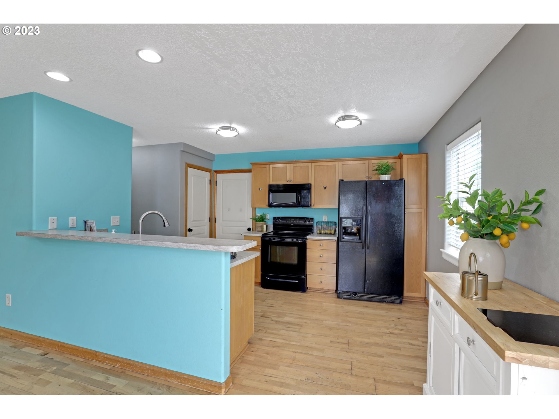 38909 Sandy Heights Street Sandy, OR 97055 - Photo 9 of 33 a kitchen with stainless steel appliances granite countertop a refrigerator a sink a stove a microwave a counter top space and cabinets