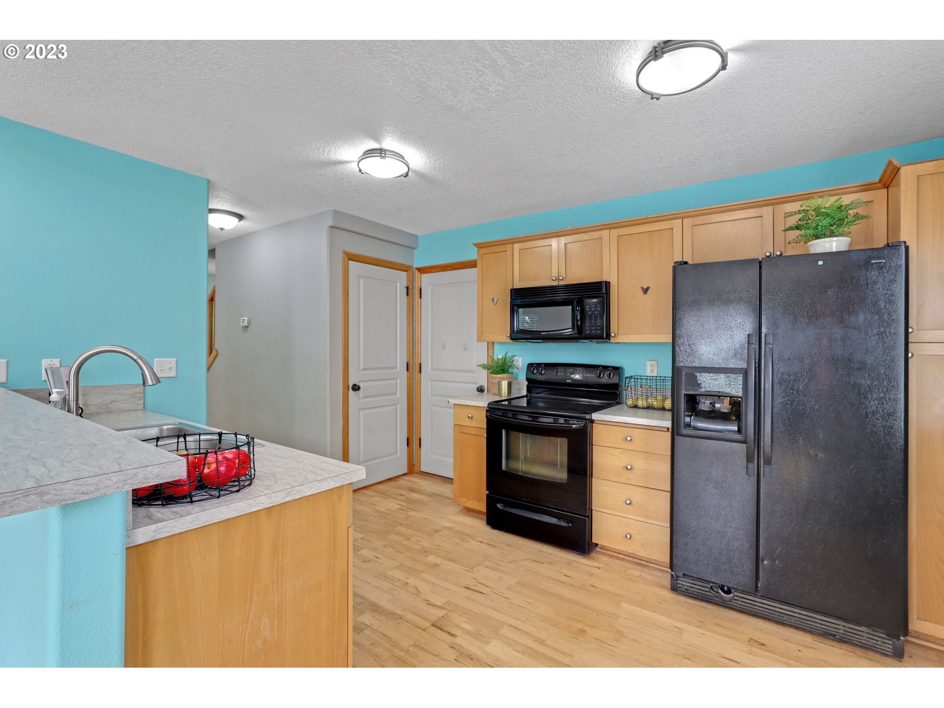 38909 Sandy Heights Street Sandy, OR 97055 - Photo 10 of 33 a kitchen with granite countertop a refrigerator and a stove top oven