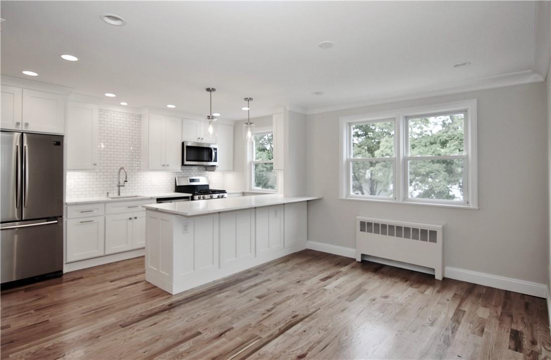 36 North Ridge Street, Unit B Rye Brook, NY 10573 - Photo 1 of 1 a kitchen with white cabinets and wooden floor