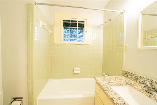 a bathroom with a bathtub and shower