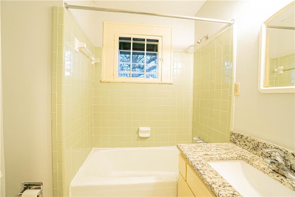 1865 Oak Grove Road Northeast Atlanta, GA 30345 - Photo 13 of 17 a bathroom with a bathtub and shower