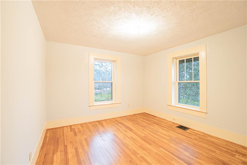 1865 Oak Grove Road Northeast Atlanta, GA 30345 - Photo 15 of 17 an empty room with wooden floor and windows