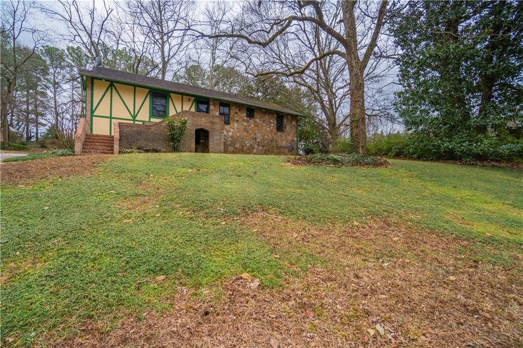 1865 Oak Grove Road Northeast Atlanta, GA 30345 - Photo 3 of 17 a backyard of a house with lots of green space