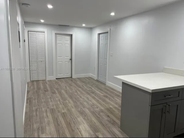 a view of hallway with wooden floor
