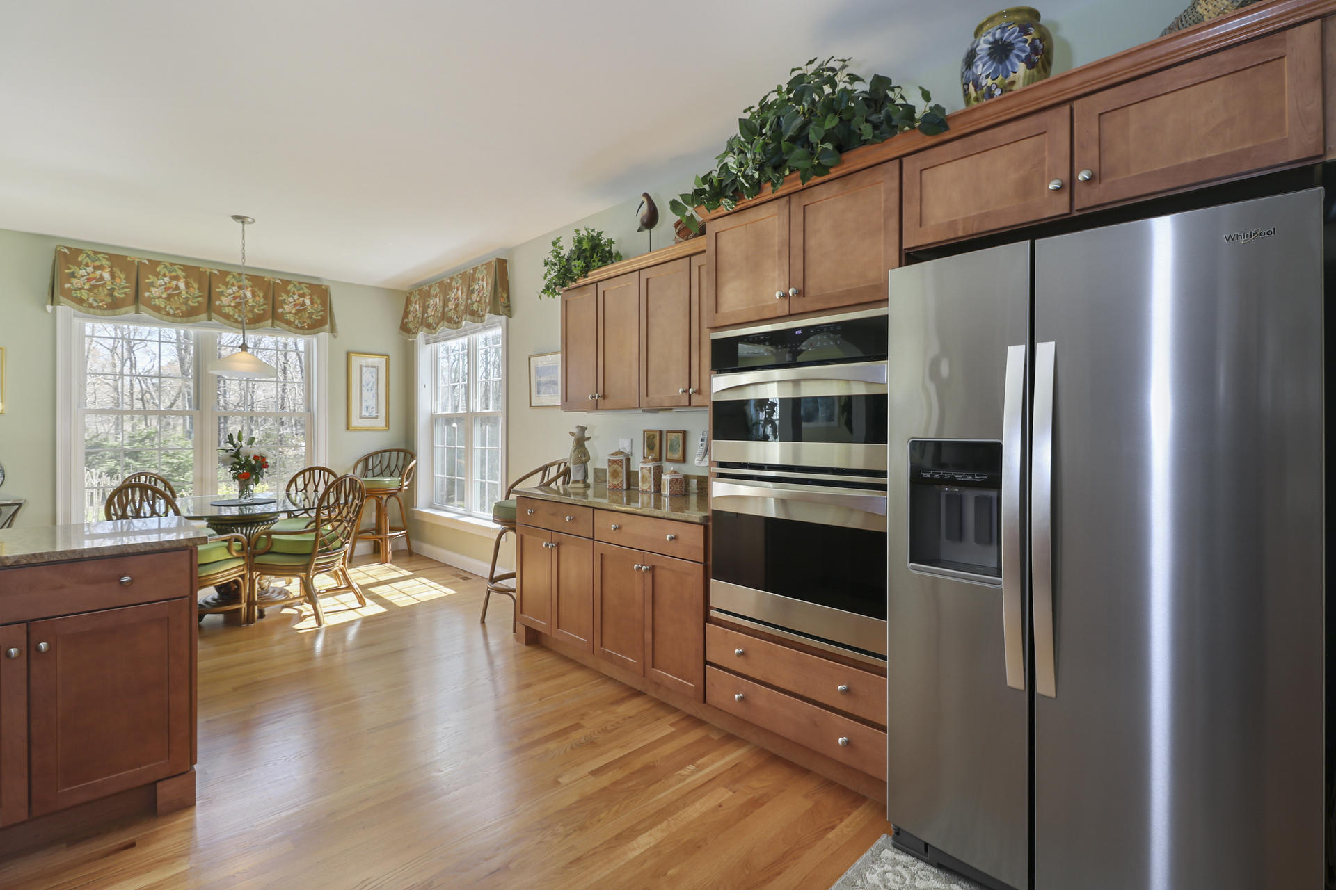 25 Dacey Drive Centerville, MA 02632 - Photo 14 of 40 a kitchen with stainless steel appliances a refrigerator a stove a dining table and chairs with wooden floor