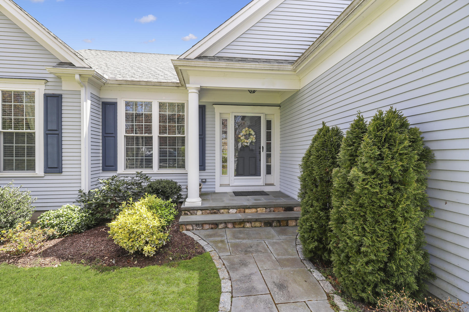 25 Dacey Drive Centerville, MA 02632 - Photo 2 of 40 a front view of a house with a garden