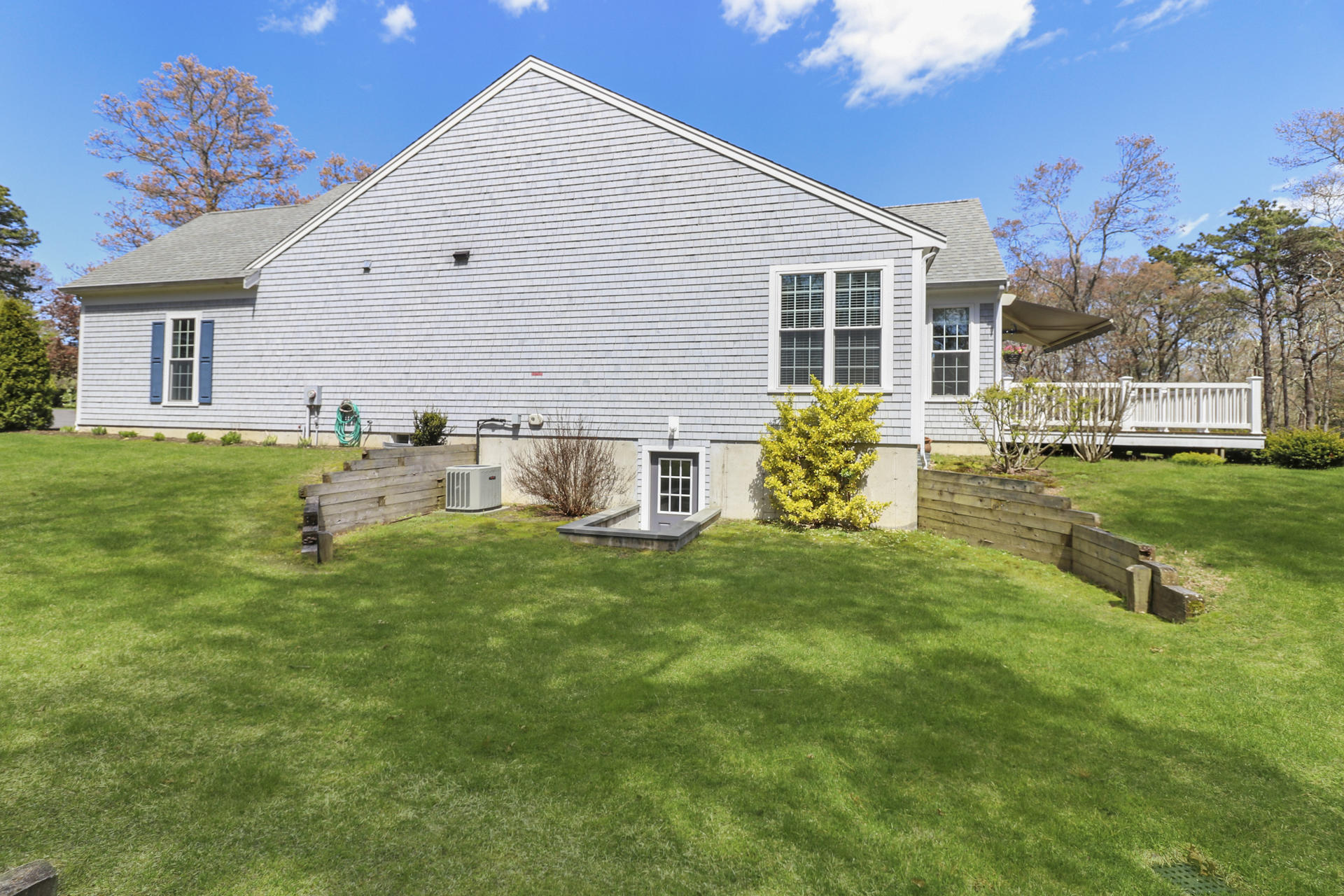 25 Dacey Drive Centerville, MA 02632 - Photo 36 of 40 a backyard of a house with table and chairs