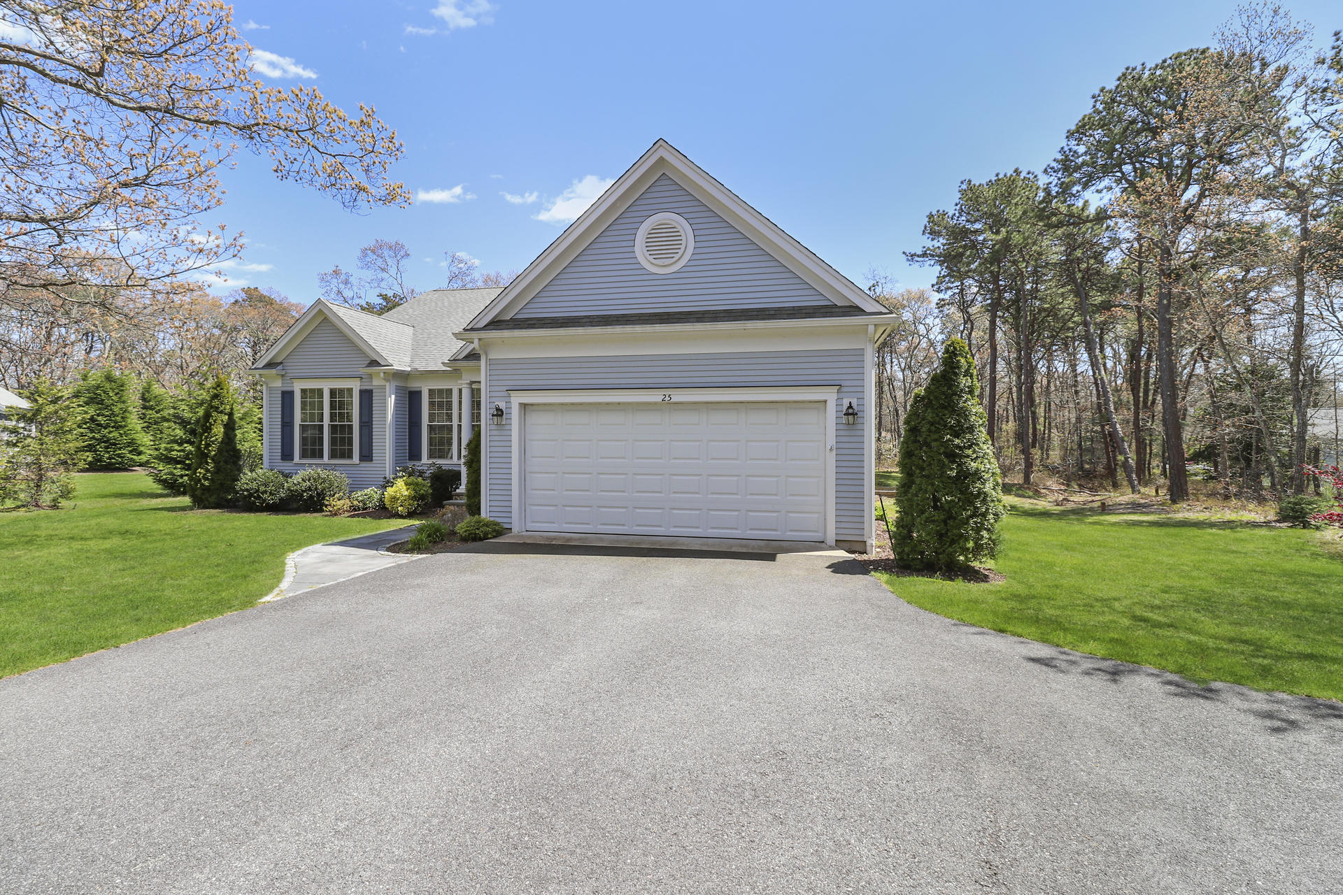 25 Dacey Drive Centerville, MA 02632 - Photo 38 of 40 a front view of a house with a yard and garage
