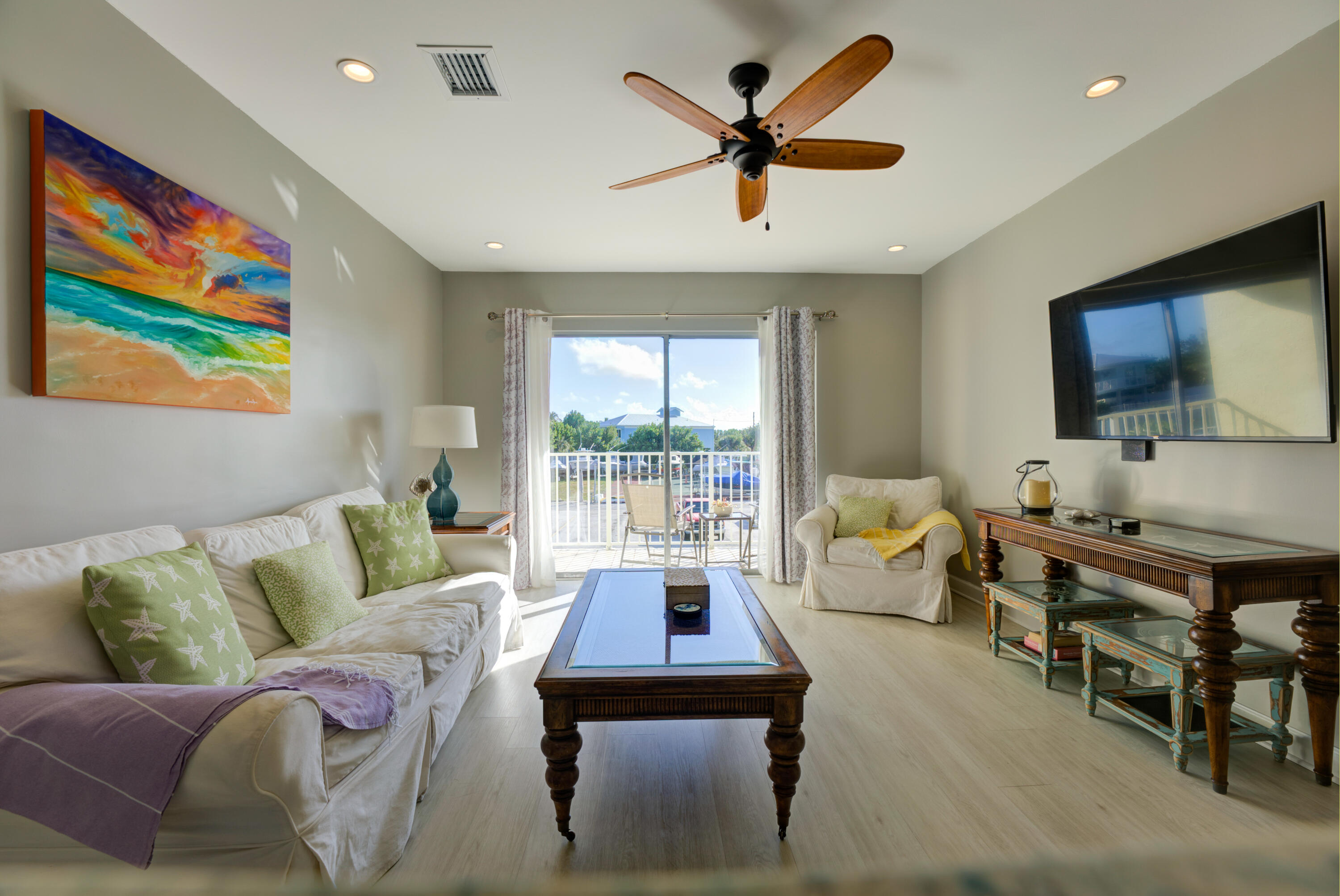 105 Ave D, Unit 113 Marathon, FL 33050 - Photo 26 of 26 a living room with furniture flat screen tv and a large window
