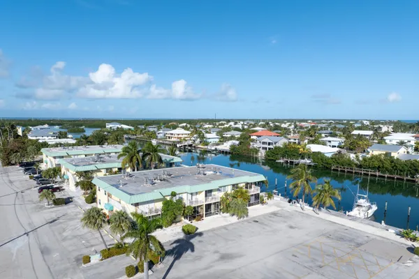 a view of a house with a yard and potted plants