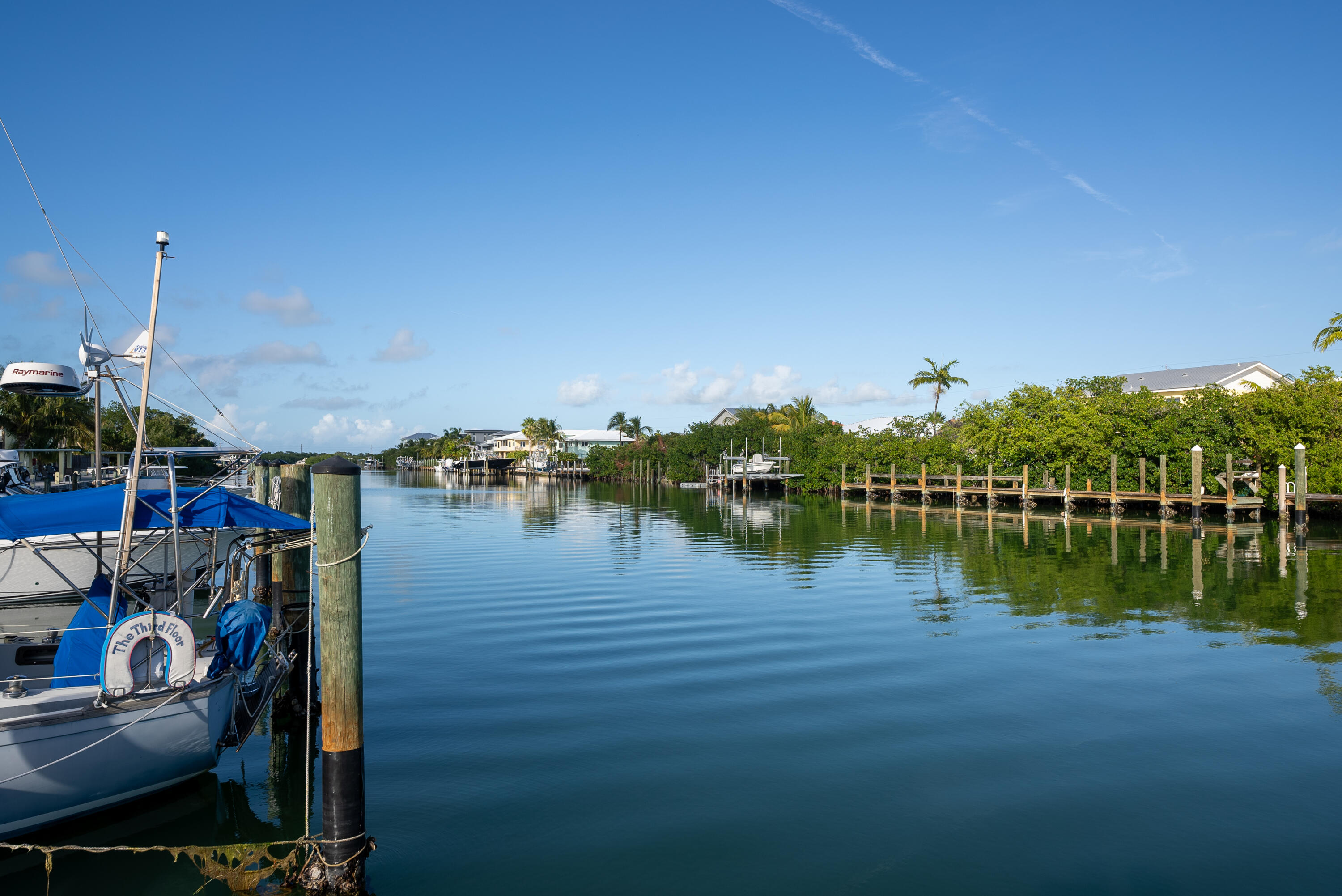 105 Ave D, Unit 113 Marathon, FL 33050 - Photo 23 of 26 a view of a lake with boats and palm trees