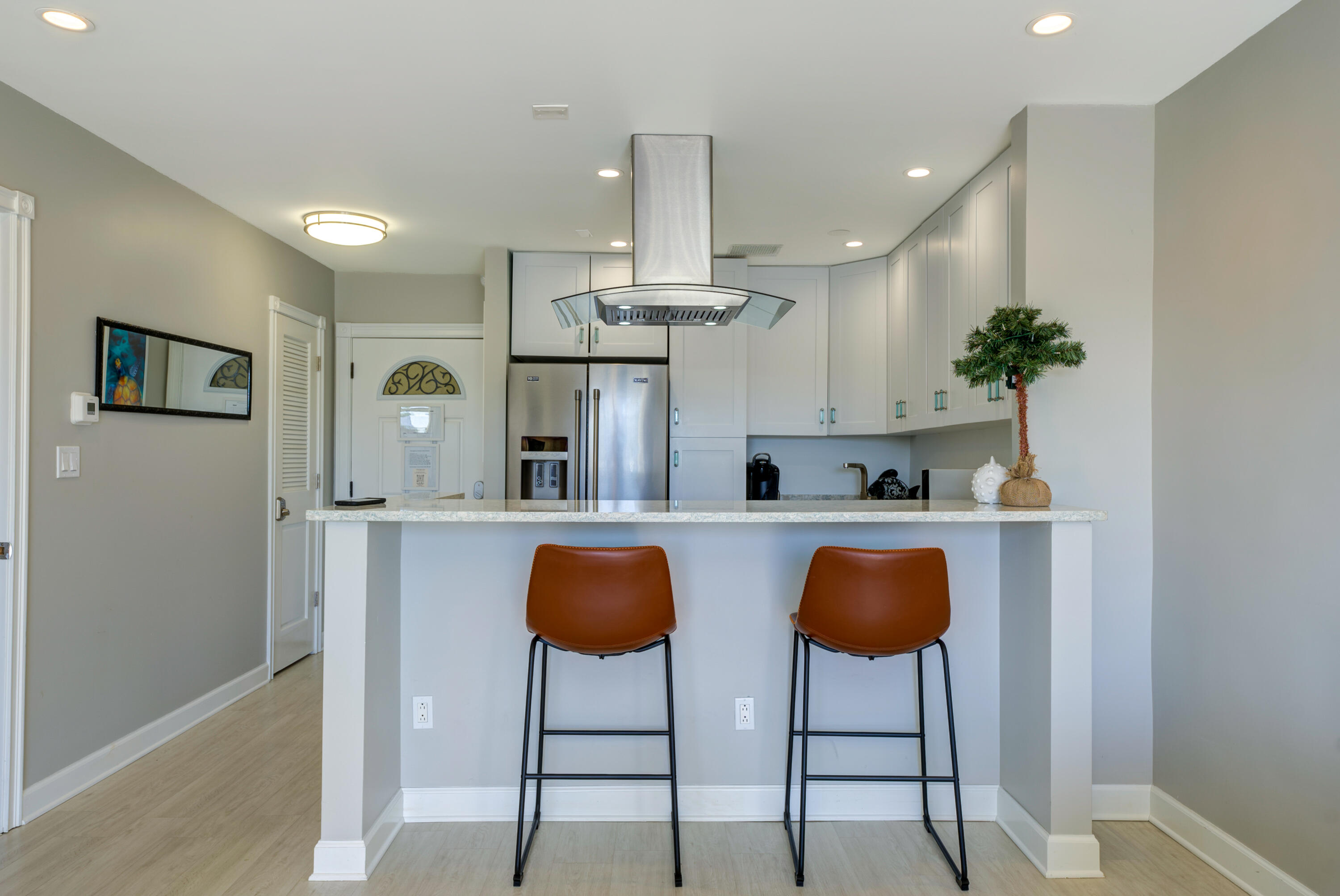 105 Ave D, Unit 113 Marathon, FL 33050 - Photo 2 of 26 a kitchen with stainless steel appliances a dining table chairs and a refrigerator