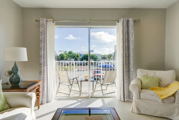 a kitchen with stainless steel appliances a dining table chairs and a refrigerator