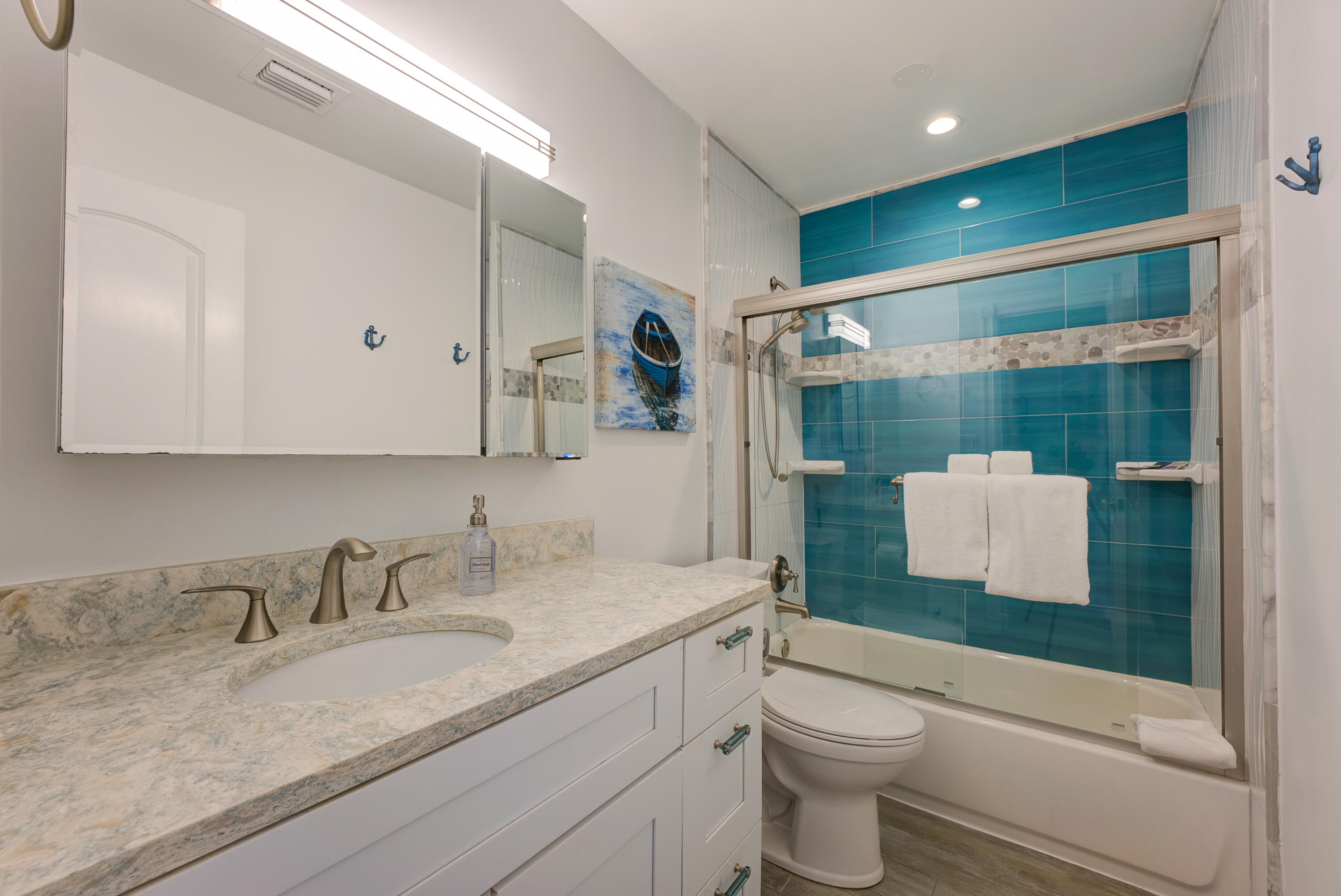 105 Ave D, Unit 113 Marathon, FL 33050 - Photo 4 of 26 a bathroom with a granite countertop sink toilet and shower