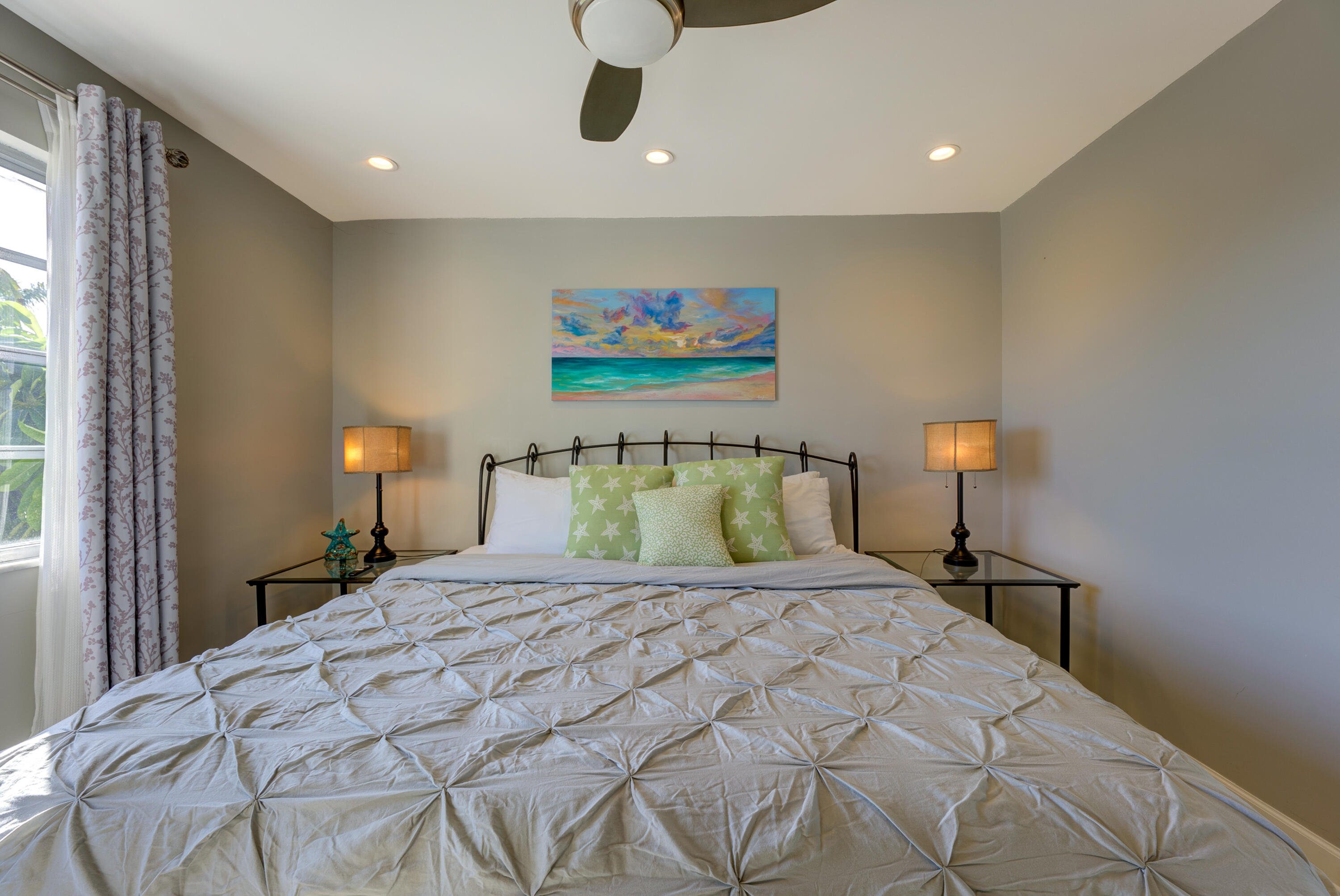 105 Ave D, Unit 113 Marathon, FL 33050 - Photo 6 of 26 a bedroom with a bed and a lamp on dresser
