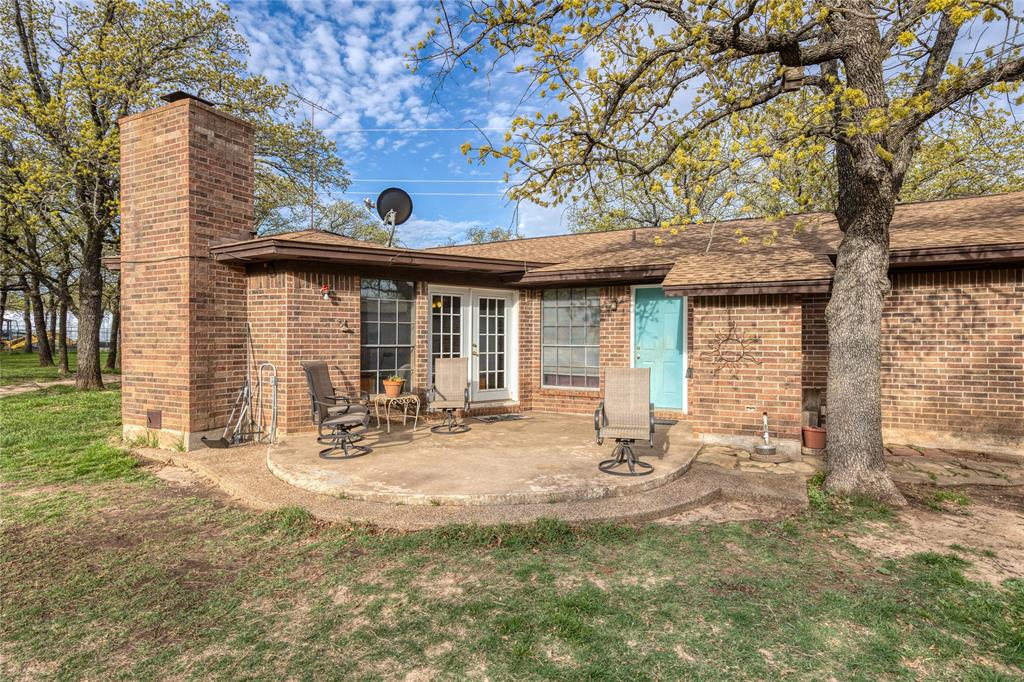 243 County Road 3851 Poolville, TX 76487 - Photo 28 of 34 a view of a house with backyard and sitting area