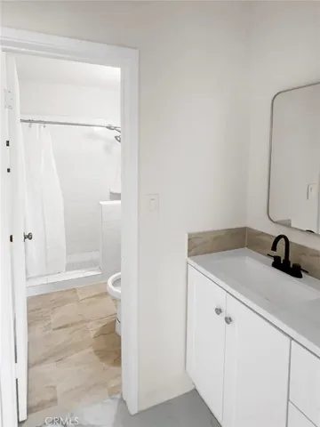 an empty room with wooden floor and white walls