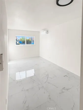 a view of kitchen with furniture and refrigerator