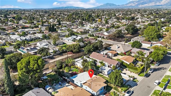 a view of a patio with a table and chairs under an umbrella