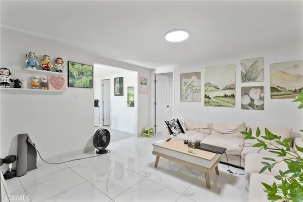 a living room with furniture and a potted plant