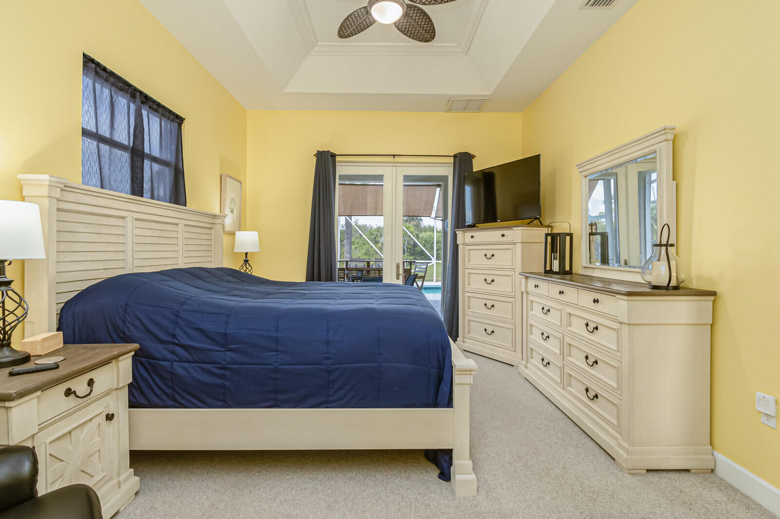 4320 S Highway Grant, FL 32949 - Photo 22 of 76 a spacious bedroom with a bed and a chandelier