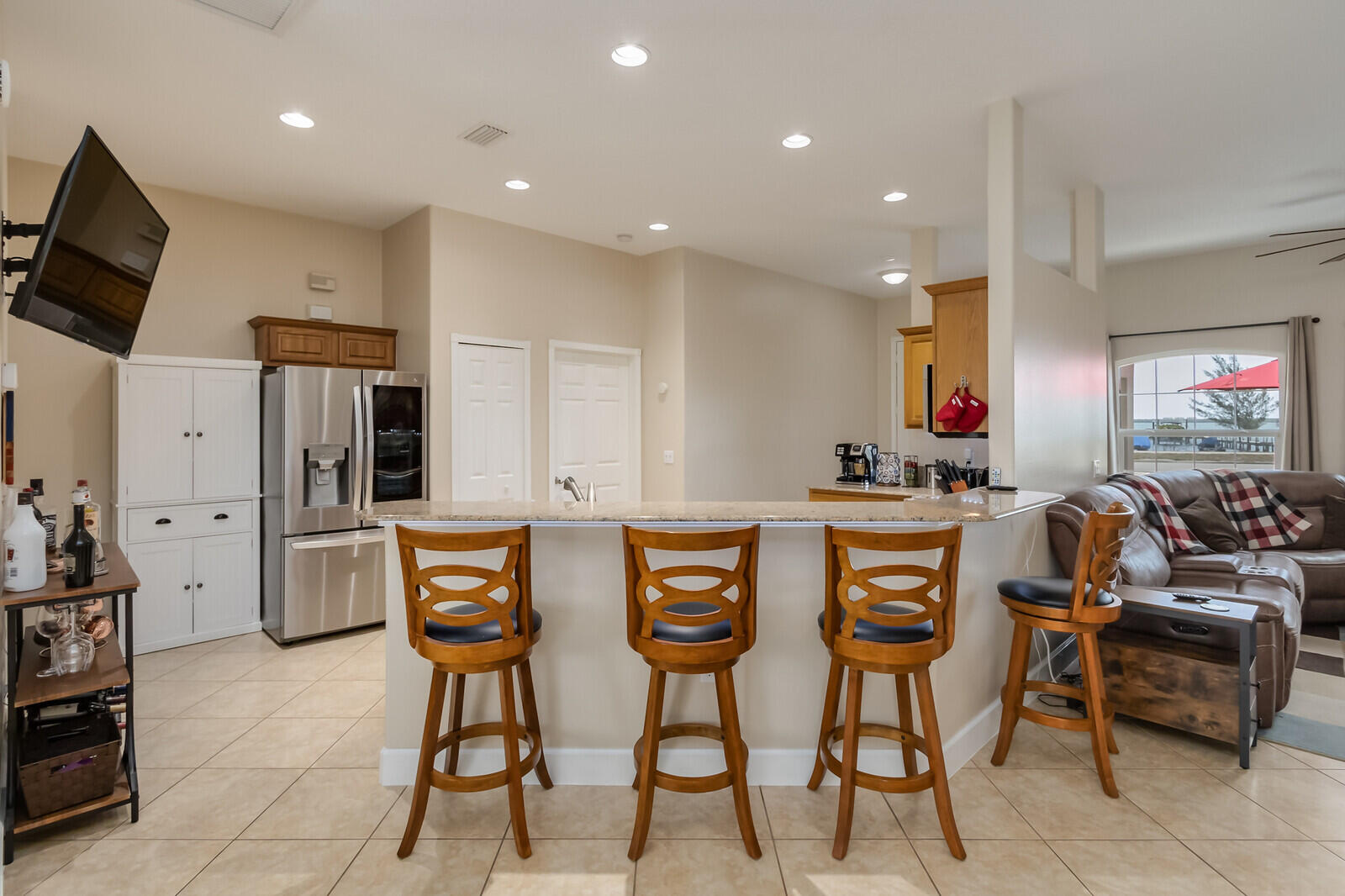 4320 S Highway Grant, FL 32949 - Photo 30 of 76 a kitchen with stainless steel appliances kitchen island granite countertop a table and chairs in it