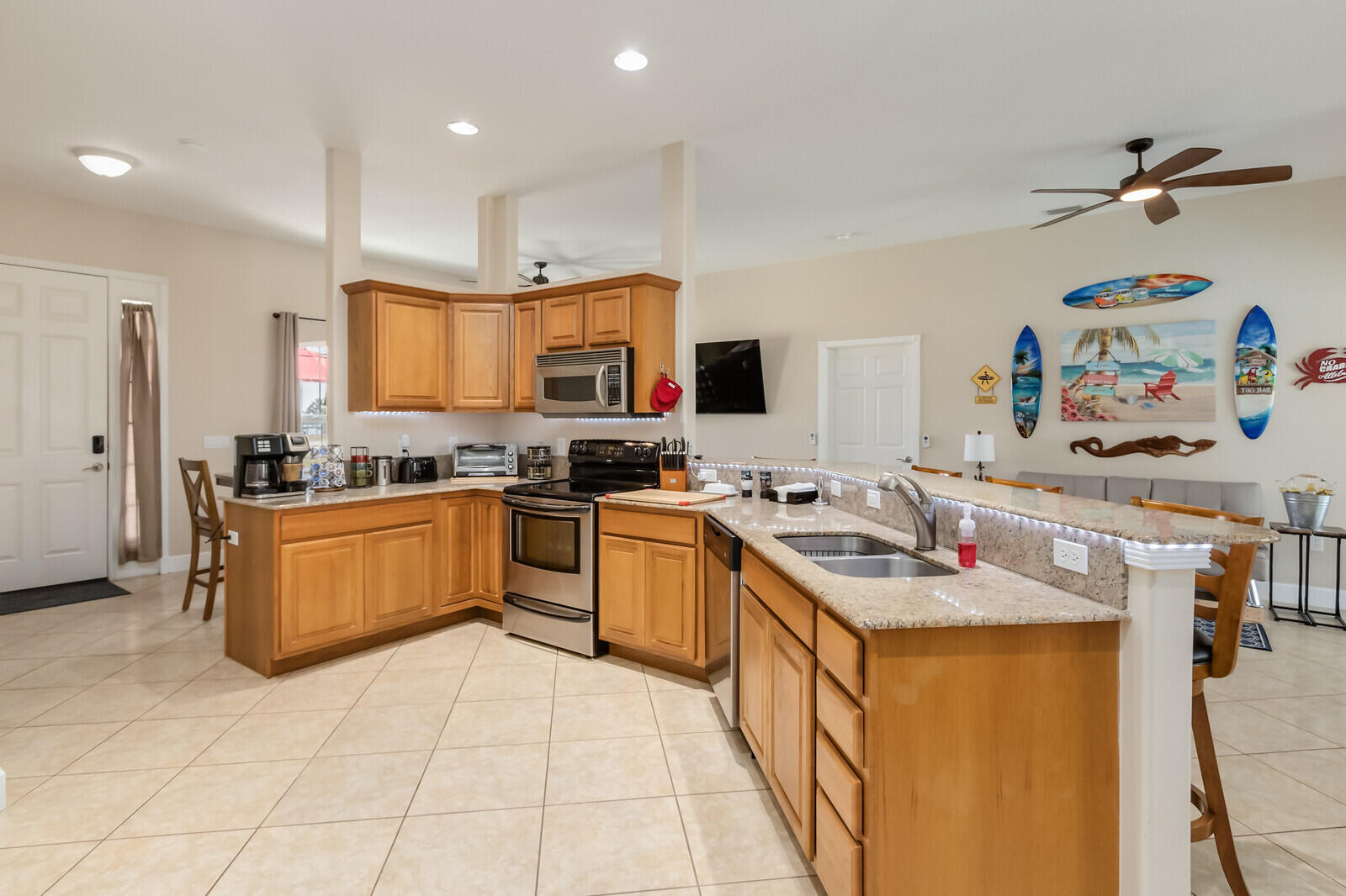 4320 S Highway Grant, FL 32949 - Photo 31 of 76 a kitchen with stainless steel appliances granite countertop a stove top oven a sink a counter space and cabinets