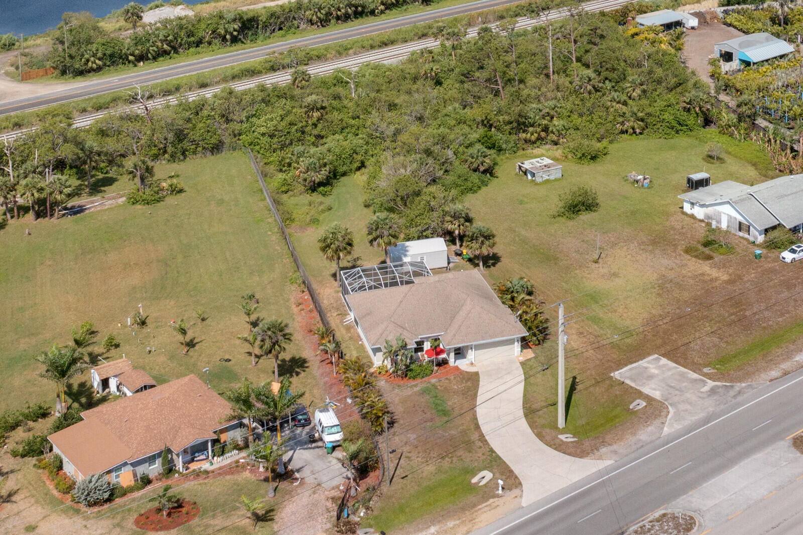 4320 S Highway Grant, FL 32949 - Photo 37 of 76 an aerial view of a house with a yard and lake view
