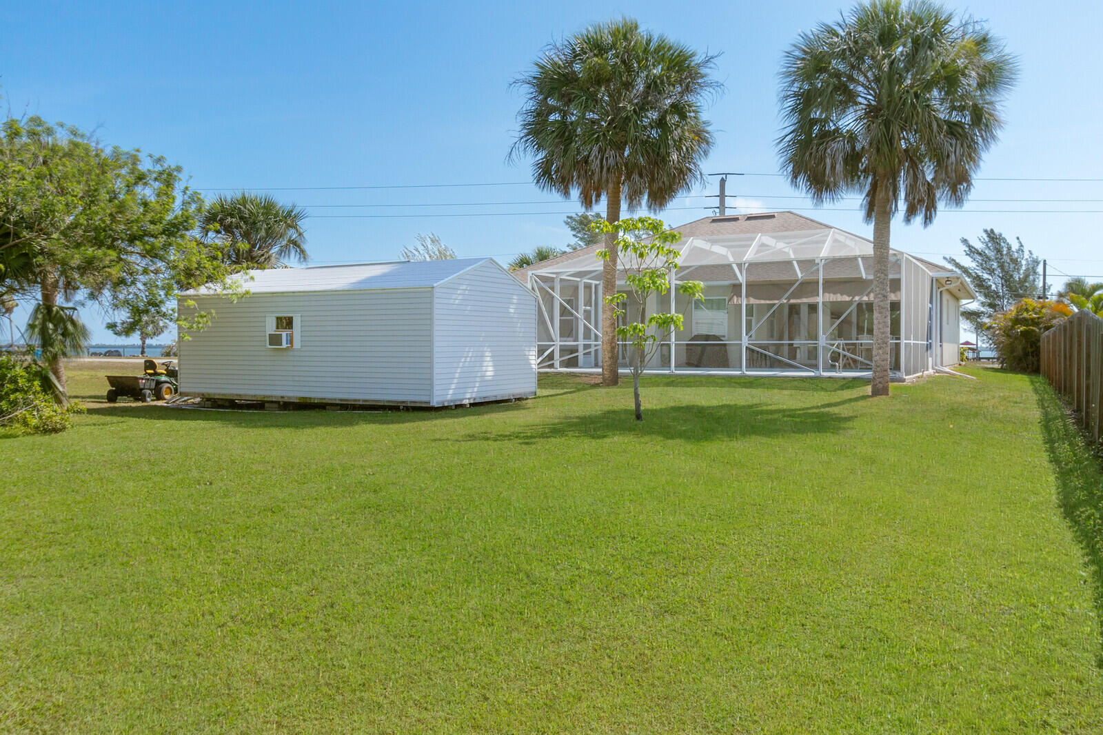 4320 S Highway Grant, FL 32949 - Photo 7 of 76 a view of a house with a big yard and palm trees