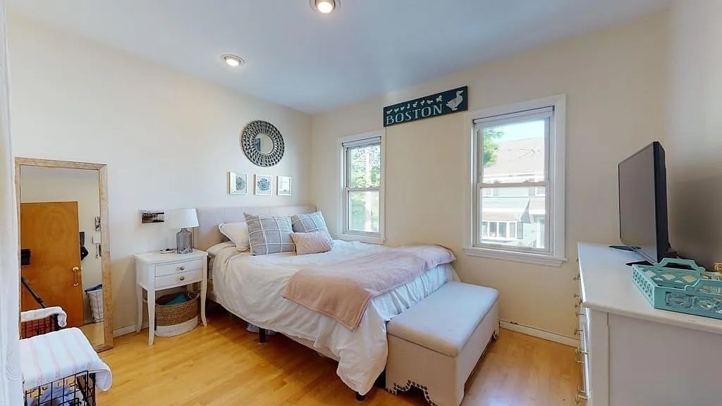 22 North Mead Street Boston, MA 02129 - Photo 3 of 7 a bedroom with a bed window and potted plant on table
