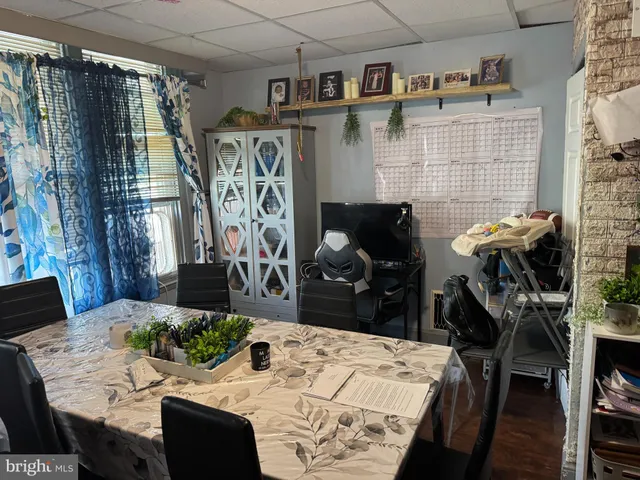 a living room with furniture and a wall painting