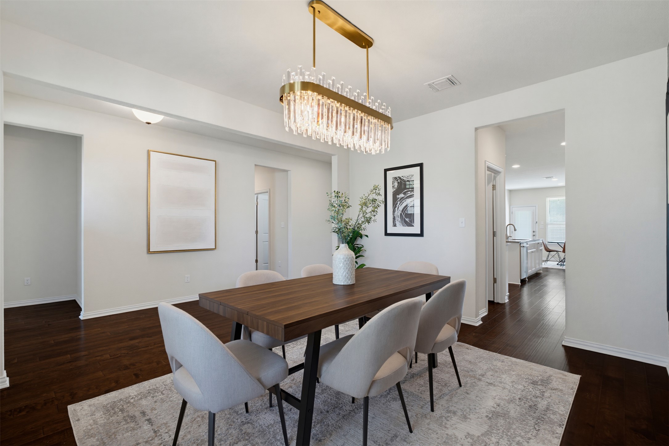 12613 Twisted Root Drive Manchaca, TX 78652 - Photo 29 of 33 A contemporary dining area featuring rich hardwood flooring and a dazzling rectangular chandelier.
