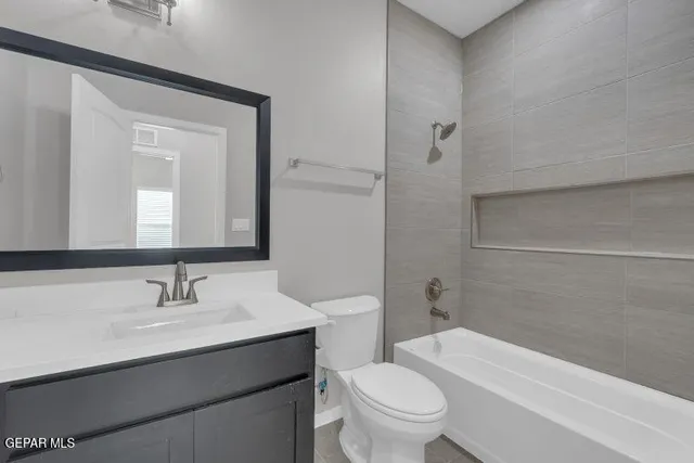 a bathroom with a sink a toilet and bathtub