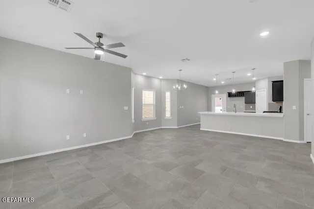 a view of an empty room with a kitchen