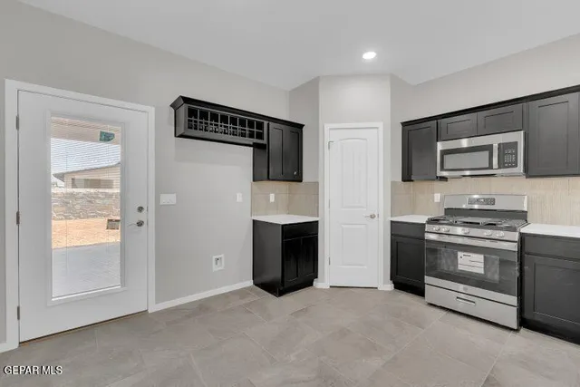 a kitchen with a refrigerator and cabinets
