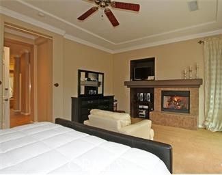 a bedroom with a bed and a television