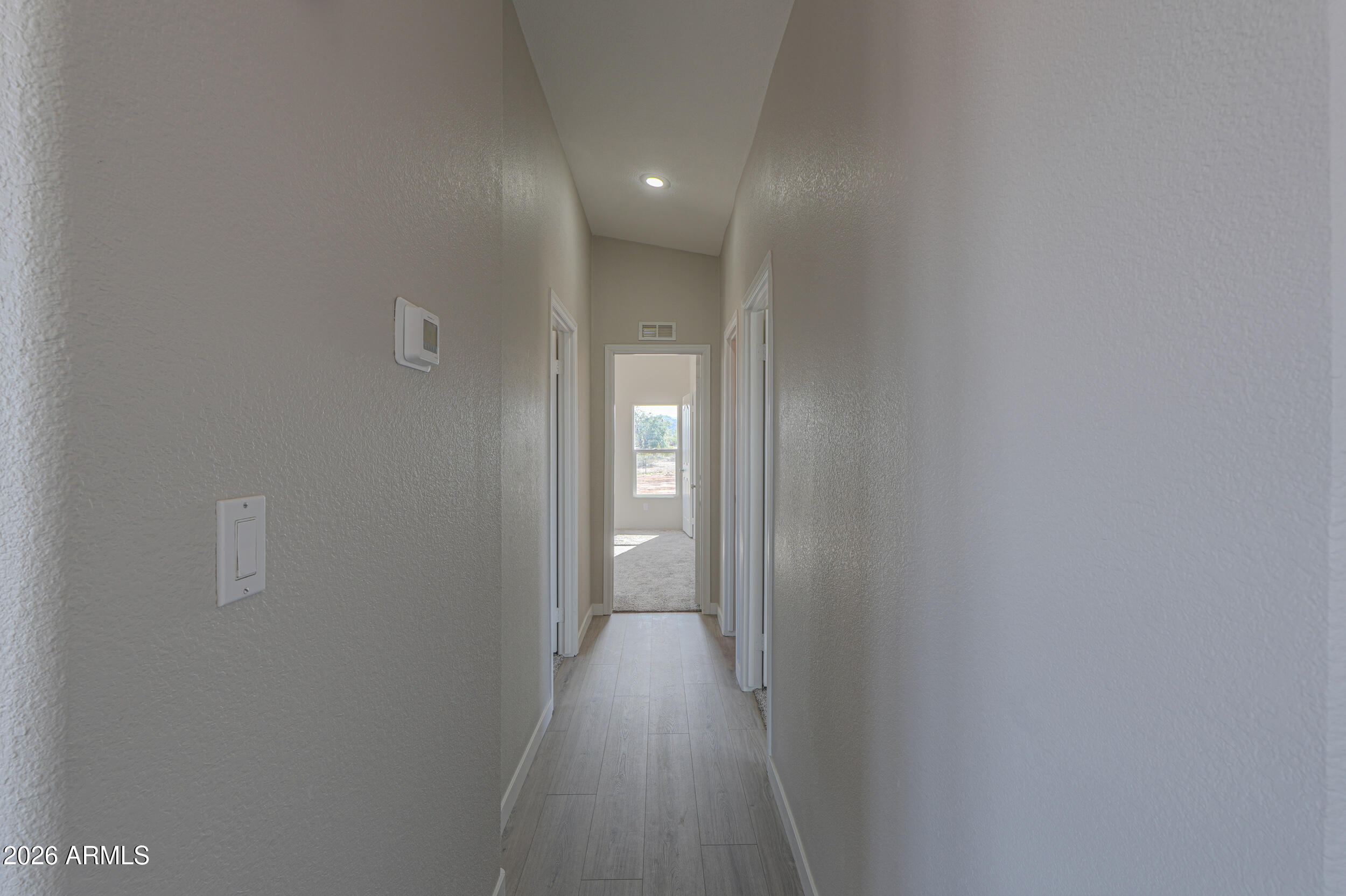 161 North Pueblo Road Maricopa, AZ 85139 - Photo 33 of 79 a view of a hallway with wooden floor