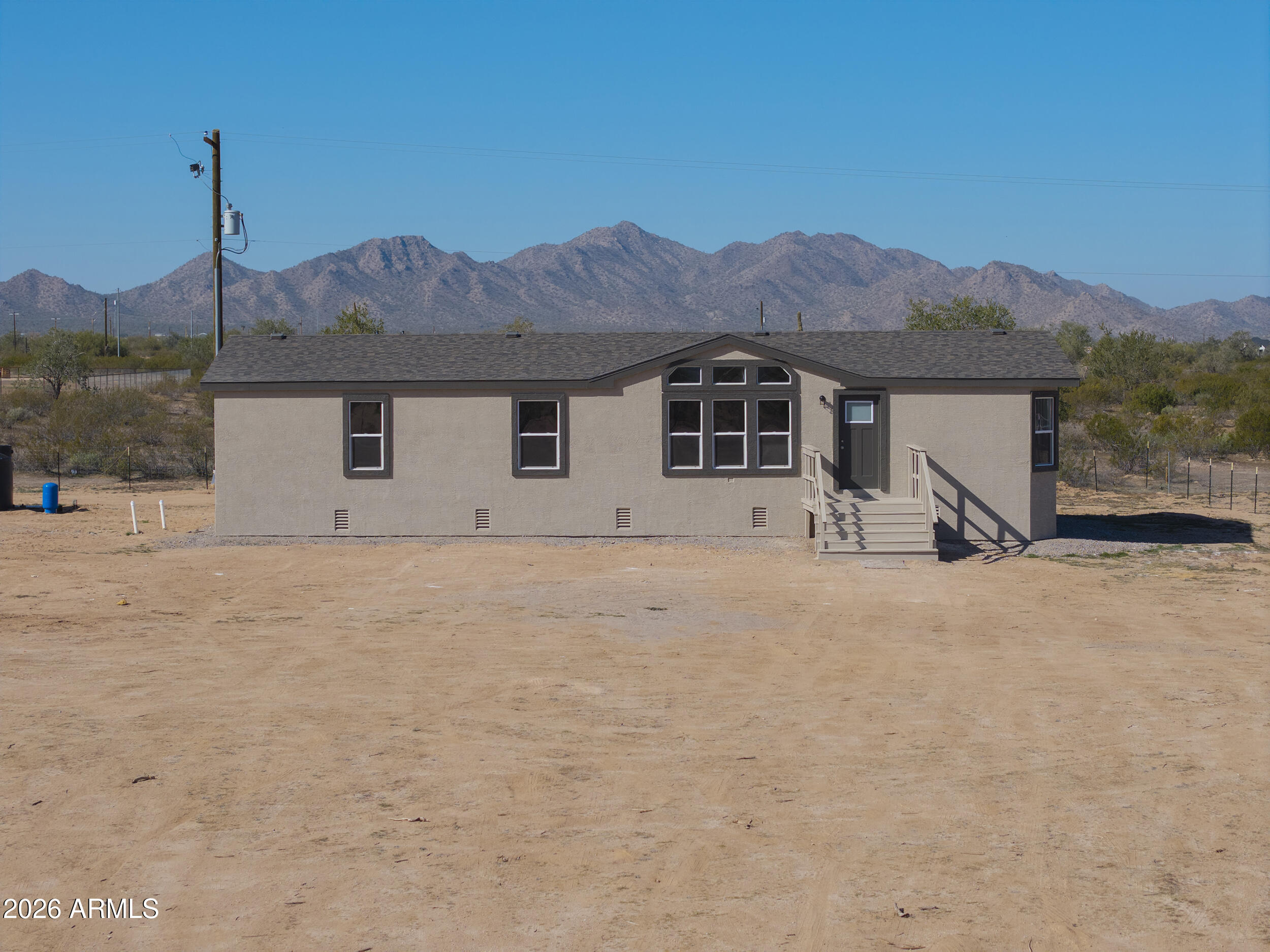 161 North Pueblo Road Maricopa, AZ 85139 - Photo 74 of 79 a front view of a house with a yard and mountain view in back