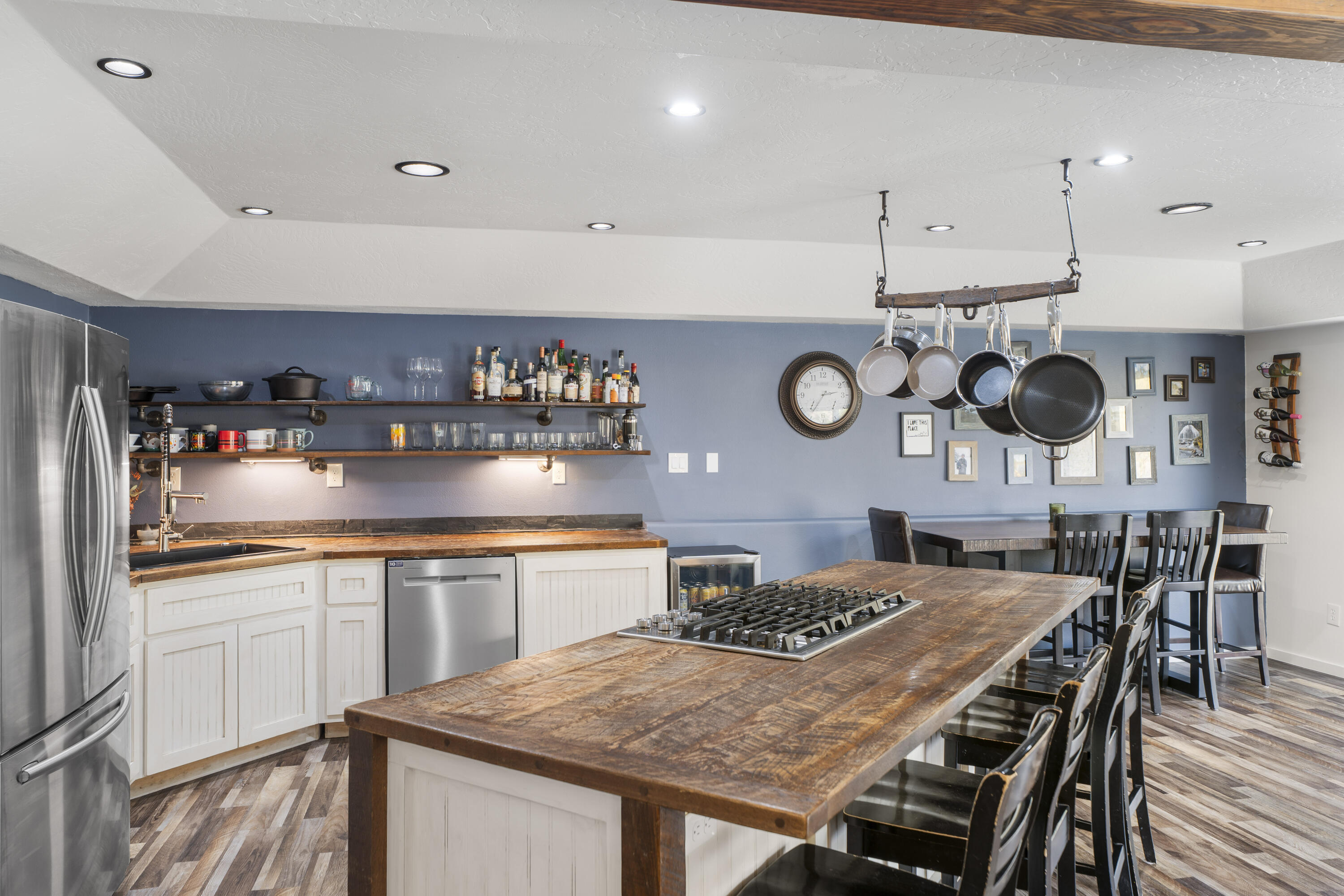 17062 Milky Way Bend, OR 97707 - Photo 11 of 39 Reclaimed wood island and countertops with gas cooktop, and hanging pot rack