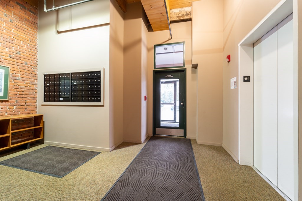 1 Envelope Terrace, Unit 309 Worcester, MA 01604 - Photo 17 of 18 a view of a hallway with wooden floor and windows
