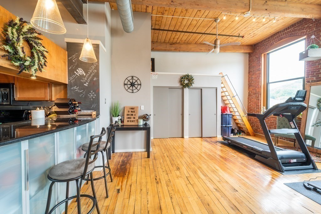 1 Envelope Terrace, Unit 309 Worcester, MA 01604 - Photo 5 of 18 a view of a dining room with furniture a chandelier and a rug