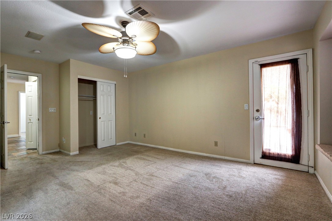 2108 Crestpoint Way Las Vegas, NV 89134 - Photo 14 of 27 A spacious bedroom offering a ceiling fan and convenient direct outdoor access.