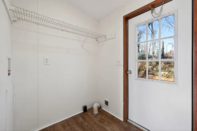 a view of a small space with wooden floor and a window