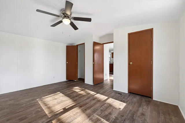 a view of empty room with wooden floor